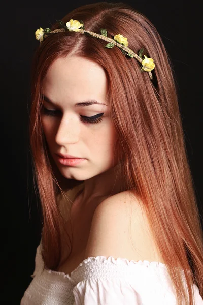 Beautiful red-haired girl black background