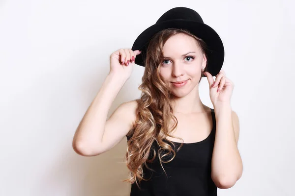 Beautiful young woman in black hat.white background. — Stock Photo, Image