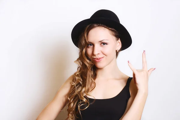 Beautiful young woman in black hat.white background. — Stock Photo, Image