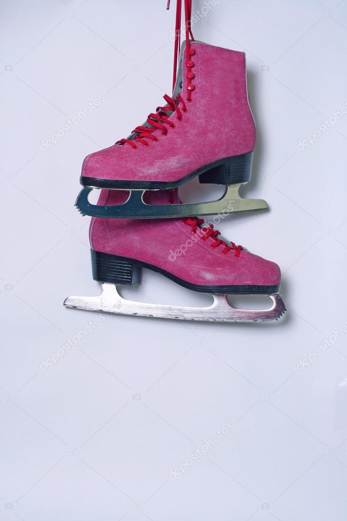 Pair of pink women's ice skates on white background — Stock Photo © visoook  #37691457