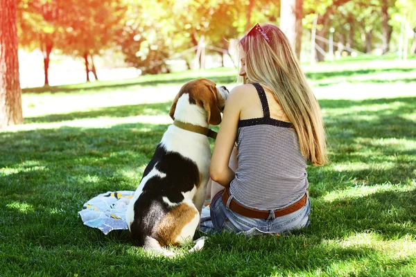 Happy young woman sit with dog and looking at dog nose — Stock Photo, Image