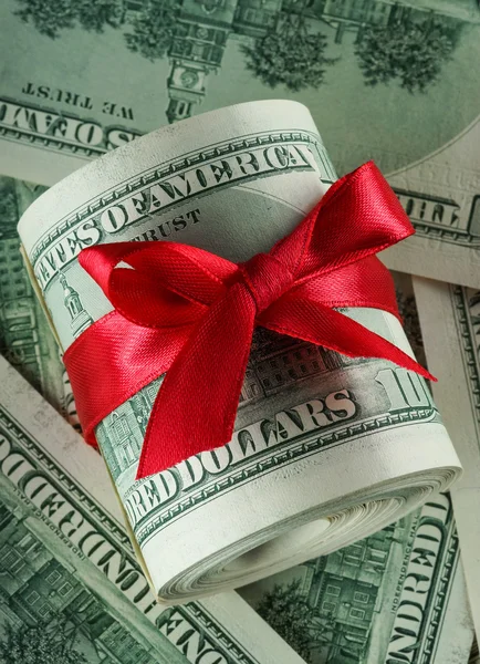 Dollars with a red bow — Stock Photo, Image