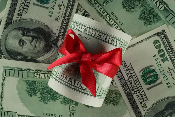 Dollars with a red bow — Stock Photo, Image