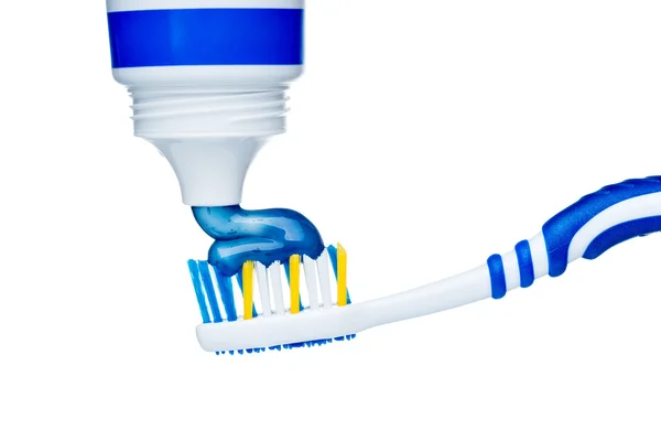 Toothpaste on blue toothbrush — Stock Photo, Image