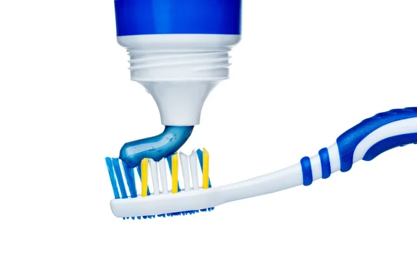 Toothpaste on blue toothbrush — Stock Photo, Image