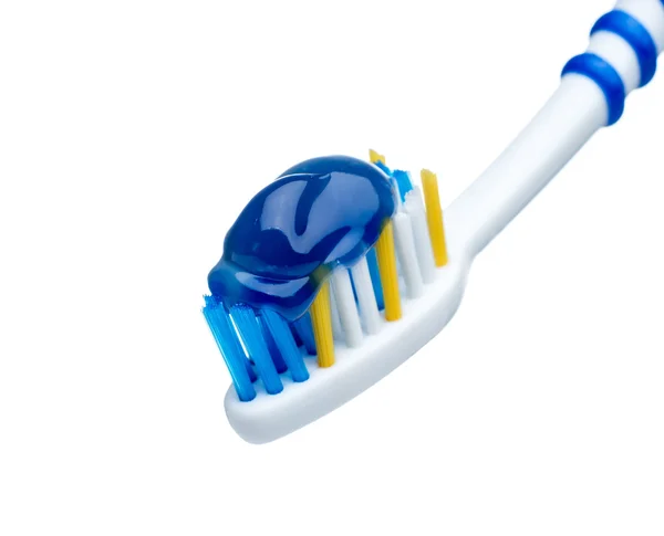 Toothpaste on blue toothbrush — Stock Photo, Image