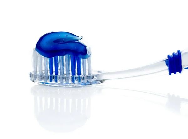 Toothpaste on blue toothbrush — Stock Photo, Image