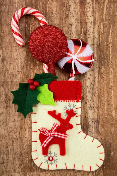 Christmas decorations and sock on wood background — Stock Photo, Image
