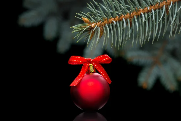 Red christmas ball on black background — Stock Photo, Image