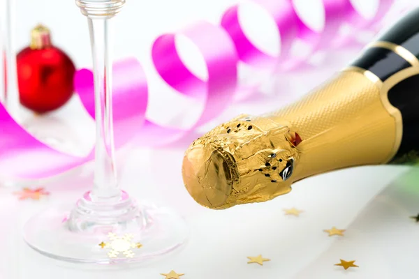 Glasses and bottle of champagne, serpentine isolated on a white background. Celebration.