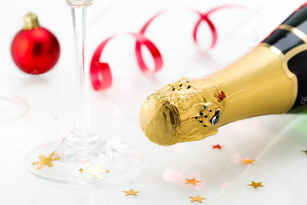 Glasses and bottle of champagne, serpentine isolated on a white background. Celebration.