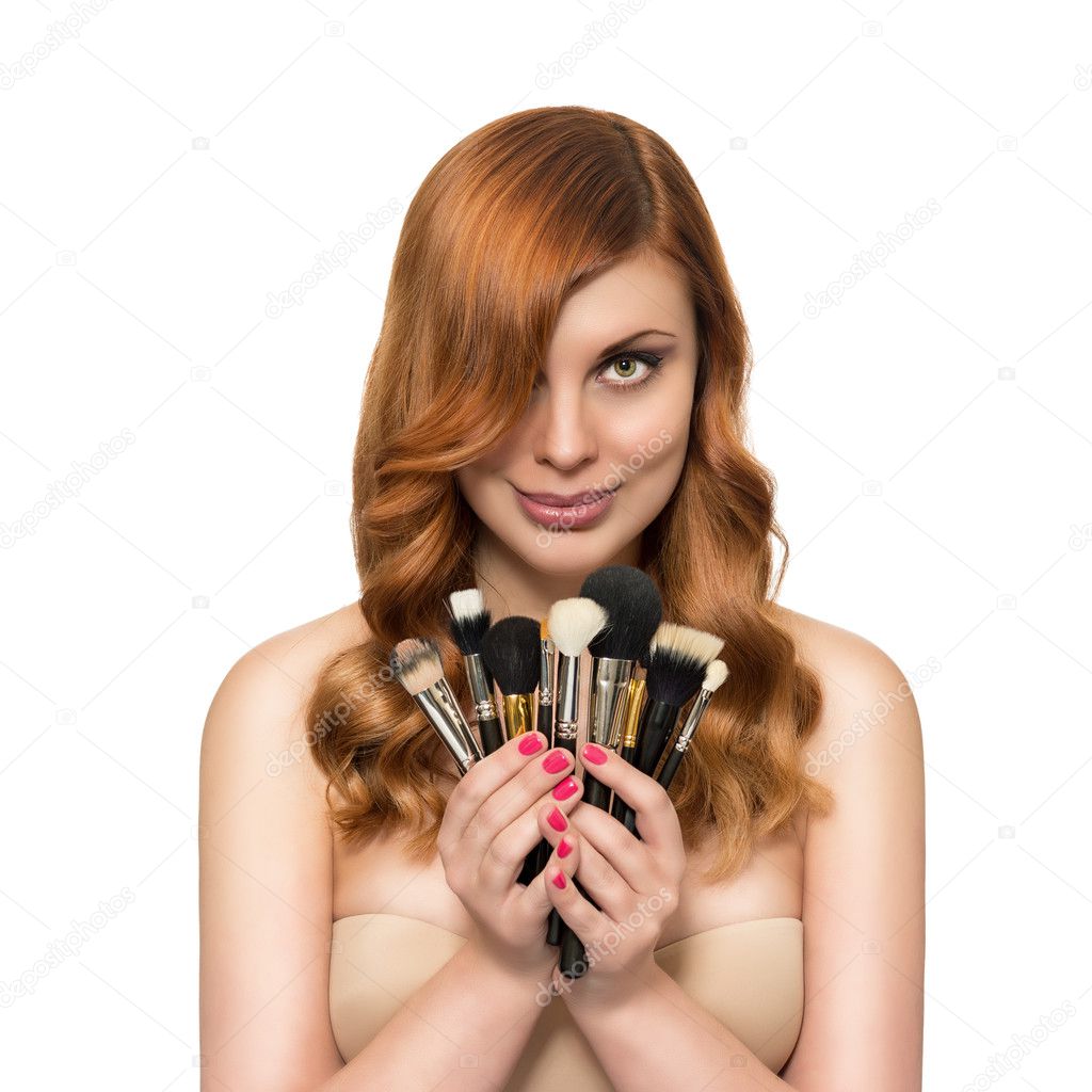 Beautiful woman with perfect skin and beauty hairstyle with brush for makeup on a white background.