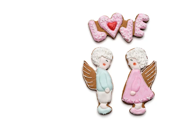 Cookies with the text of love and couple of angels on Valentine 's day — стоковое фото