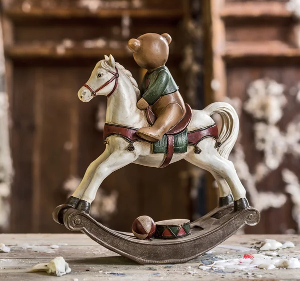 Vintage old rocking horse on a wooden background — Stock Photo, Image
