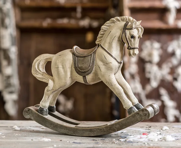 Vintage old rocking horse on a wooden background — Stock Photo, Image