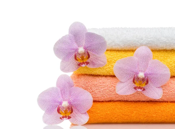 Colorful towels and flower isolated on white — Stock Photo, Image