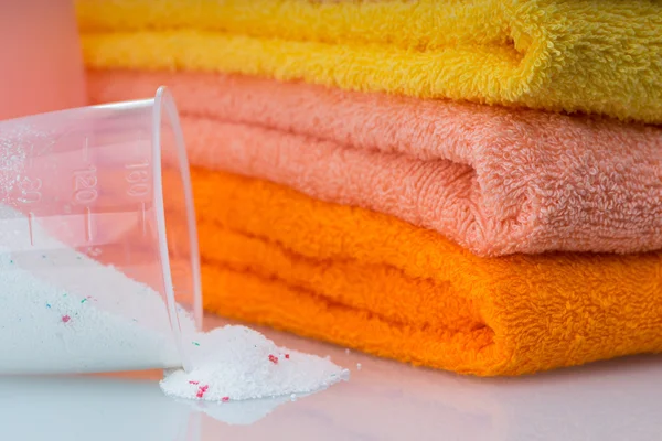 Detergent for washing machine in laundry with towels in the white background. — Stock Photo, Image