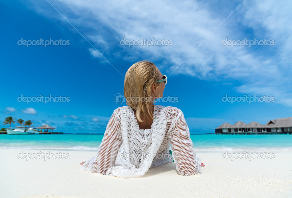 Beach vacation. Hot beautiful woman enjoying looking view of beach ocean on hot summer day.