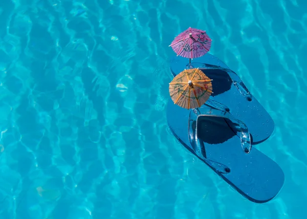 Flip Flop on pool with surface of water background — Stock Photo, Image