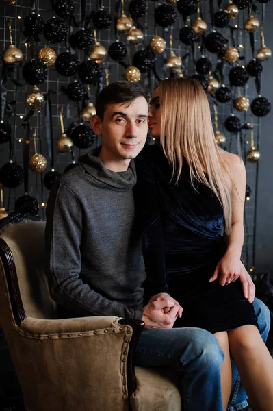 A girl in a beautiful dress sits on her knees in a guy — Stock Photo, Image