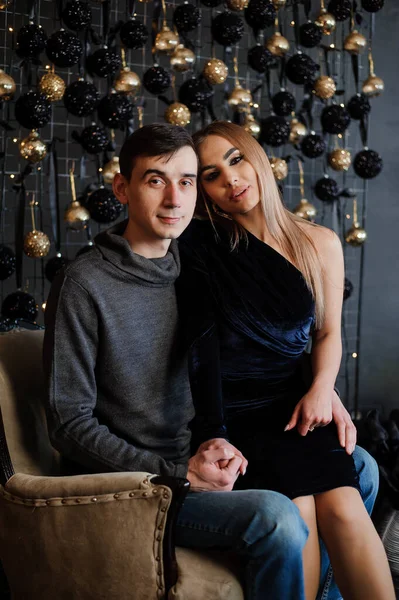 Uma menina em um vestido bonito se senta de joelhos em um cara — Fotografia de Stock