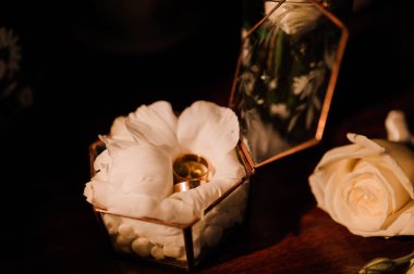 Düğün aksesuarları. Altın alyanslar, damatlar yaka çiçeği