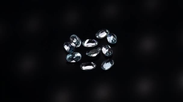 Natural blue topaz gemstones on the dark background turning table — Stock Video