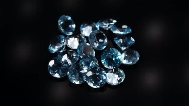 Natural blue topaz gemstones on the dark background turning table — Stock Video