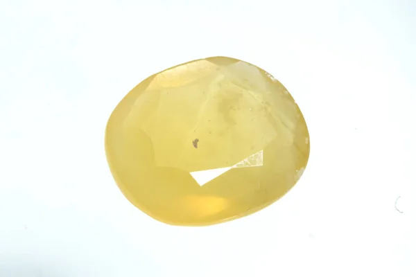Natural gemstone yellow sapphire on white background