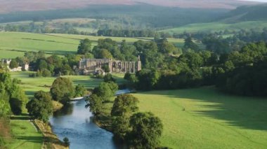 Early morning sunshine illuminates Bolton Abbey in Wharfedale, North Yorkshire, England, takes its name from the ruins of the 12th-century Augustinian monastery now known as Bolton Priory