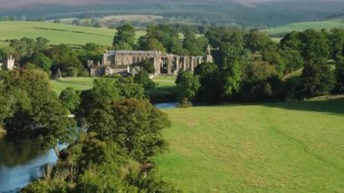 Early morning sunshine illuminates Bolton Abbey in Wharfedale, North Yorkshire, England, takes its name from the ruins of the 12th-century Augustinian monastery now known as Bolton Priory
