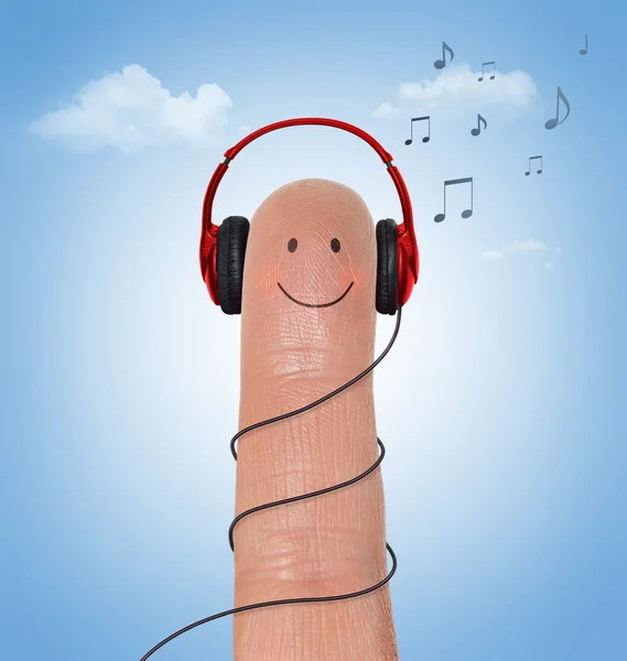 Red headphones on happy finger — Stock Photo, Image