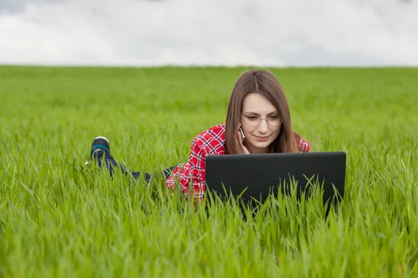 Hermosa mujer elegante de pie en un prado verde — Foto de Stock