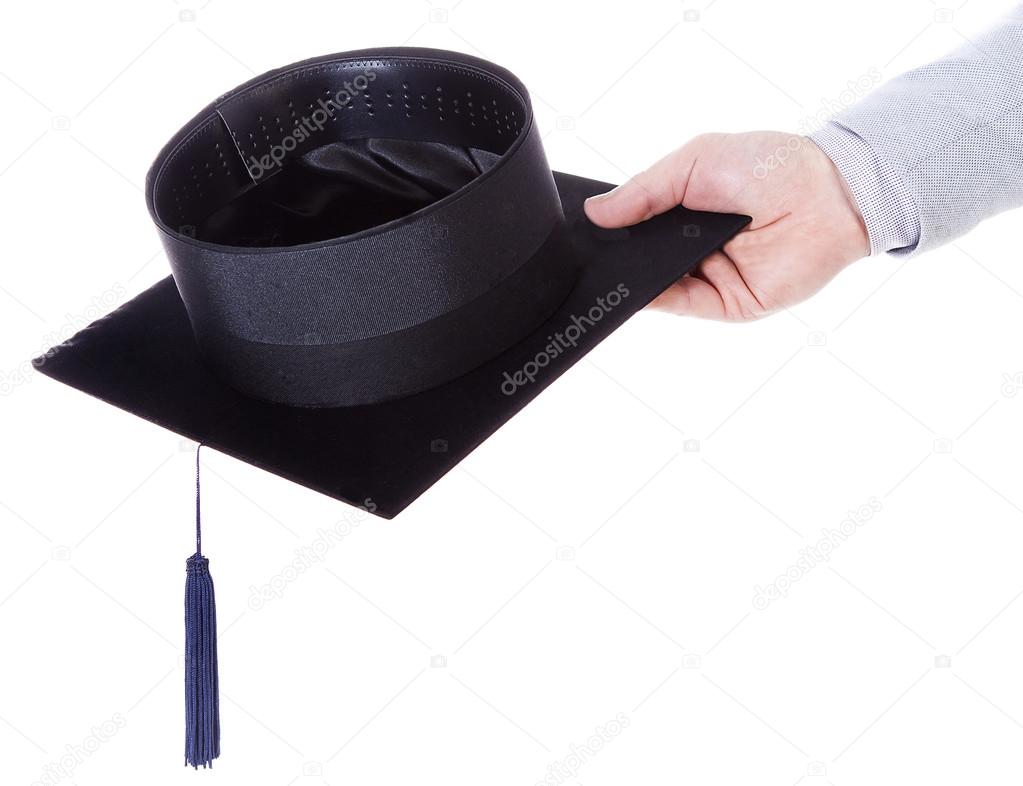 mortarboard academic graduation cap in the hand
