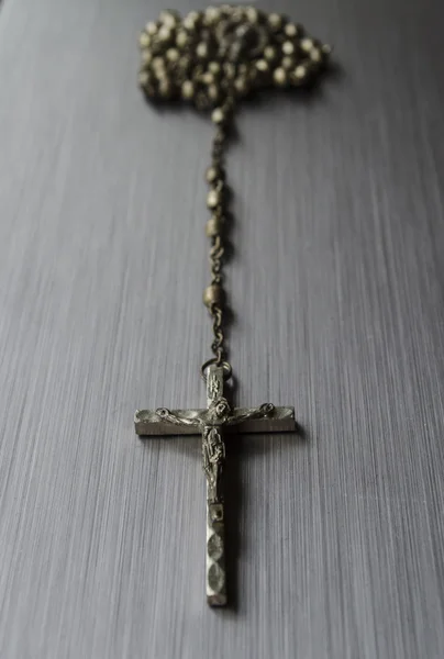Rosary beads on brushed metal — Stok fotoğraf