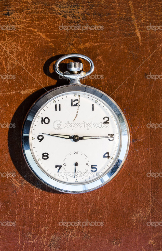 Pocket watch on leather background