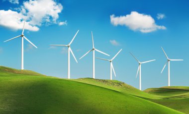 Wind turbines on green hills clipart