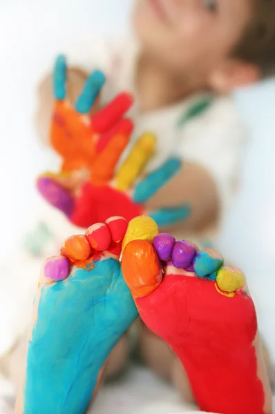 Happy child with painted feet and hands — Stock Photo, Image