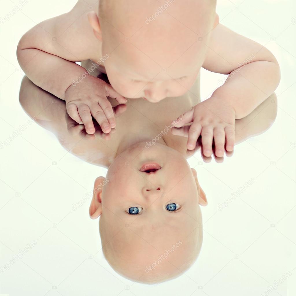 Amazed six months old baby looking at the mirror — Stock Photo