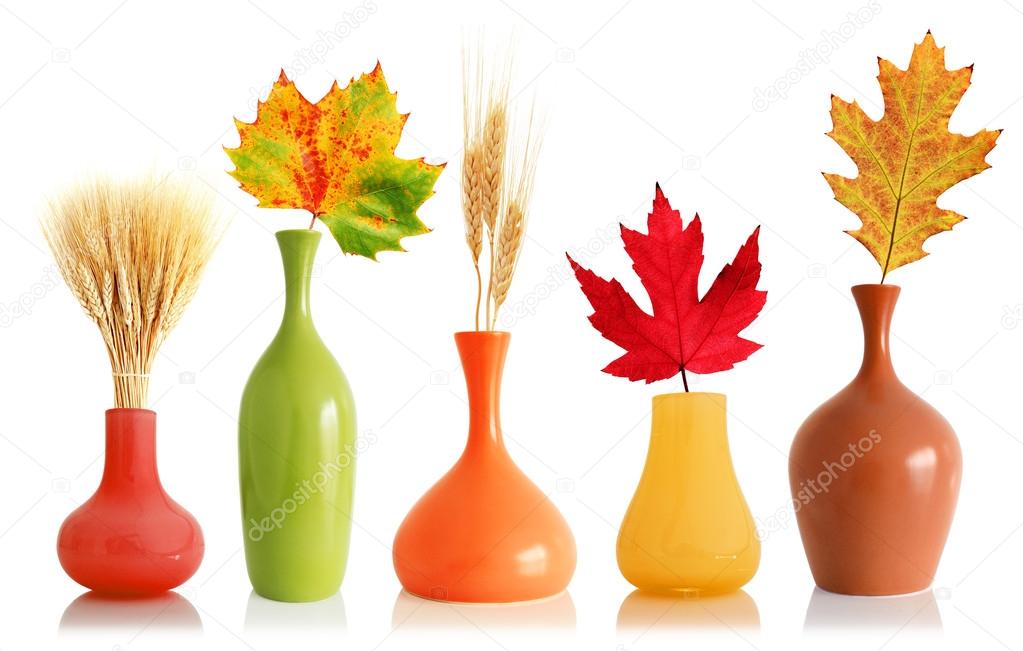 Colorful leaves and wheat in vases