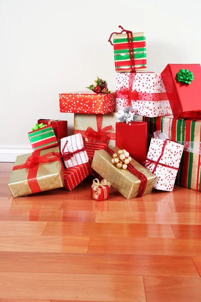 Geschenke stapeln sich auf einem Fußboden — Stockfoto