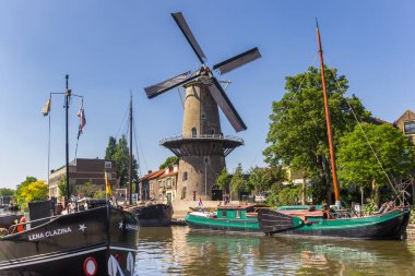 Historic windmill De Roode Leeuw in the harbor of Gouda, Netherlands clipart