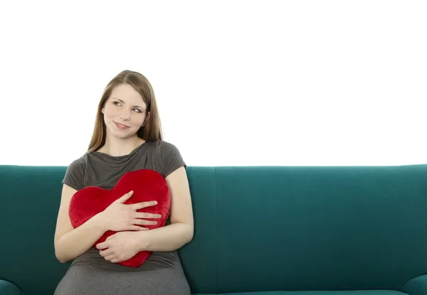 Woman with heart pillow — Stock Photo, Image