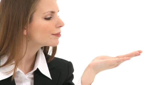 Woman blows something from her hand with copy space above her hand — Stock Video