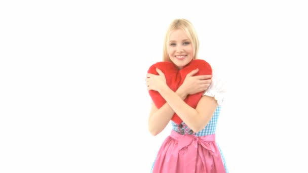 Woman in Dirndl with heart pillow — Stock Video