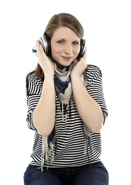 Young smiling woman listens to music — Stock Photo, Image