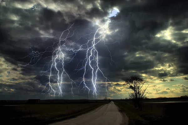 Storm met bliksemschichten over weg — Stockfoto