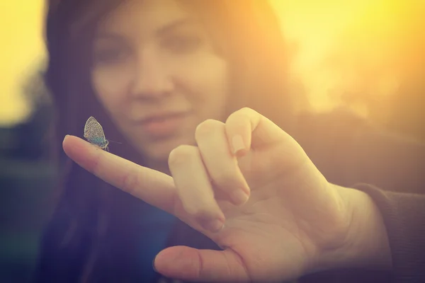 A woman holding a beetle on a finger — Stock Photo, Image