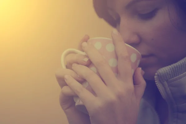 Vintage photo of tired woman drinking morning coffee or tea — Stock Photo, Image