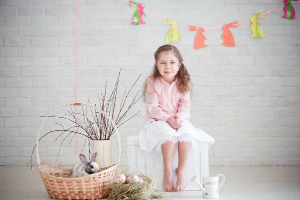 Little girl with rabbit and easter decorations — Stock Photo, Image